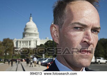 A frowning politician in front of the US Capitol Building View Large Photo Image Stock Image - A frowning politician in front of the US Capitol Building. Fotosearch