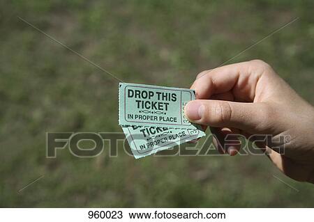 A girl holding two tickets, detail of hand View Large Photo Image Stock Image - A girl holding two tickets, detail of hand. Fotosearch