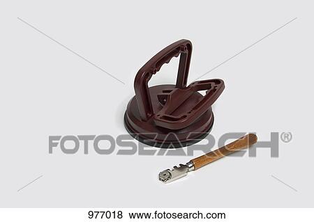 A glass cutter and a suction pad View Large Photo Image Stock Photo - A glass cutter and a suction pad. Fotosearch