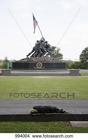 A homeless man sleeping in front of the Iwo Jima Memorial View Large Photo Image Picture - A homeless man sleeping in front of the Iwo Jima Memorial. Fotosearch