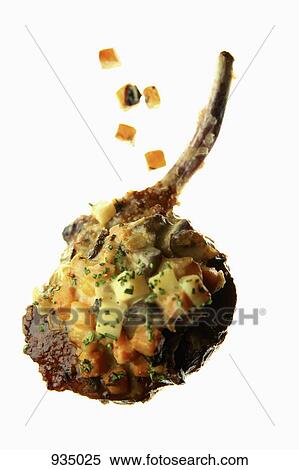 Stock Photography - A lamb cutlet with carrot salsa on a lightbox. Fotosearch
