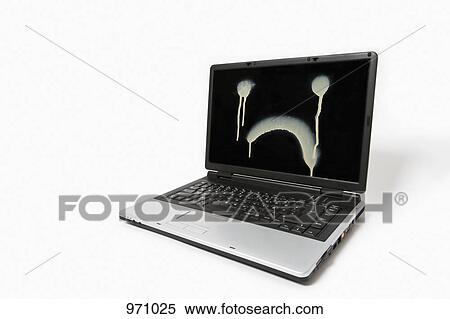 Stock Photography - A laptop monitor with a sad face spray painted on it. Fotosearch