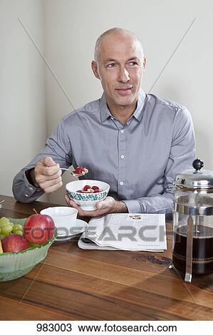 Stock Image - A man having breakfast. Fotosearch