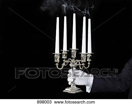 A man holding a candelabra with extinguished candles View Large Photo Image Stock Image - A man holding a candelabra with extinguished candles. Fotosearch