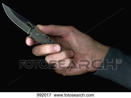 A man holding a penknife, directly below, hand only View Large Photo Image Stock Photo - A man holding a penknife, directly below, hand only. Fotosearch