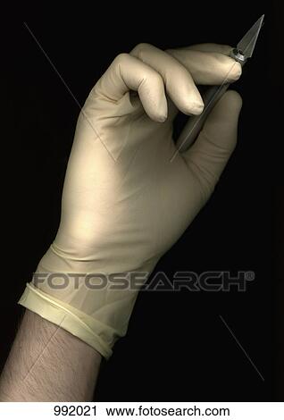 A man wearing a surgical glove and holding a scalpel, directly below, hand only View Large Photo Image Stock Image - A man wearing a surgical glove and holding a scalpel, directly below, hand only. Fotosearch