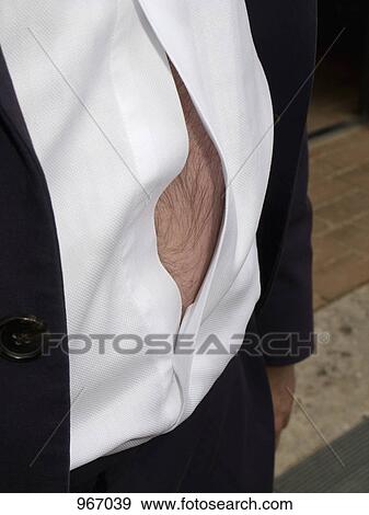 A man wearing an unbuttoned shirt View Large Photo Image Stock Photo - A man wearing an unbuttoned shirt. Fotosearch