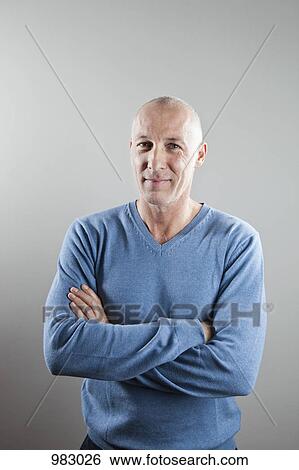 A man with his arms crossed, portrait View Large Photo Image Stock Photograph - A man with his arms crossed, portrait. Fotosearch