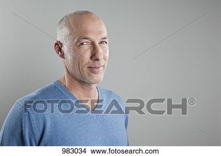 A mature man looking suspicious, portrait View Large Photo Image Picture - A mature man looking suspicious, portrait. Fotosearch