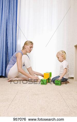 A mother and daughter playing with toy blocks View Large Photo Image Stock Photograph - A mother and daughter playing with toy blocks. Fotosearch