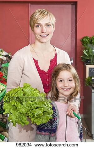 A mother and daughter shopping at the supermarket View Large Photo Image Picture - A mother and daughter shopping at the supermarket. Fotosearch