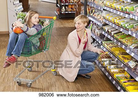 A mother and daughter shopping at the supermarket View Large Photo Image Stock Photograph - A mother and daughter shopping at the supermarket. Fotosearch