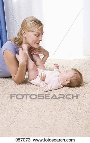 Stock Image - A mother playing with her baby daughter. Fotosearch