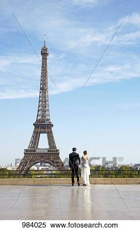 A newlywed couple in front of the Eiffel Tower, Paris, France View Large Photo Image Stock Photography - A newlywed couple in front of the Eiffel Tower, Paris, France. Fotosearch