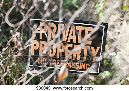 A NO TRESPASSING sign behind a chain-link fence View Large Photo Image Stock Image - A NO TRESPASSING sign behind a chain-link fence. Fotosearch