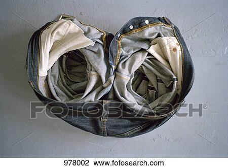 Stock Image - A pair of crumpled jeans on the floor. Fotosearch