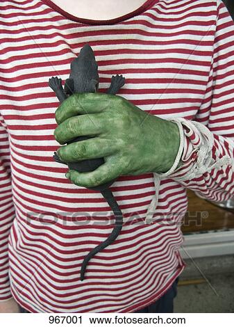 A person with a green hand holding a toy rat View Large Photo Image Stock Image - A person with a green hand holding a toy rat. Fotosearch