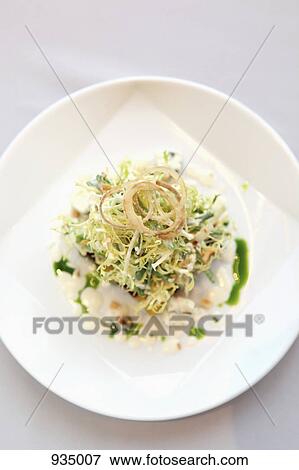 Stock Photo - A salad garnished with fried onions. Fotosearch