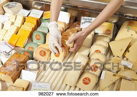 A sale clerk in a cheese shop, focus on hands View Large Photo Image Stock Photo - A sale clerk in a cheese shop, focus on hands. Fotosearch