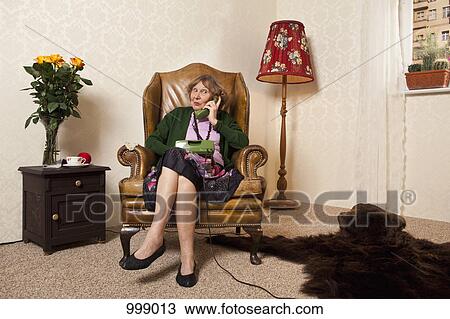 A senior woman gossiping on the phone View Large Photo Image Stock Image - A senior woman gossiping on the phone. Fotosearch
