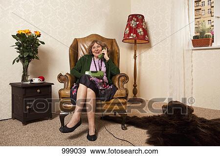 A senior woman on the phone at home View Large Photo Image Stock Photo - A senior woman on the phone at home. Fotosearch