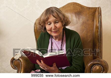 A senior woman reading a book View Large Photo Image Stock Photography - A senior woman reading a book. Fotosearch