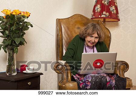 Stock Photo - A senior woman using a laptop. Fotosearch