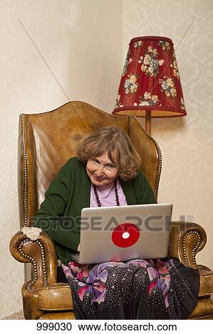 Stock Image - A senior woman with a laptop. Fotosearch