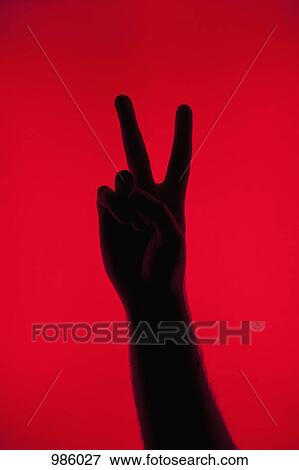 A silhouetted hand making a peace sign View Large Photo Image Stock Photo - A silhouetted hand making a peace sign. Fotosearch