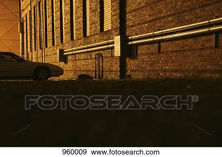 A single car parked in a shadowy parking lot View Large Photo Image Stock Photo - A single car parked in a shadowy parking lot. Fotosearch