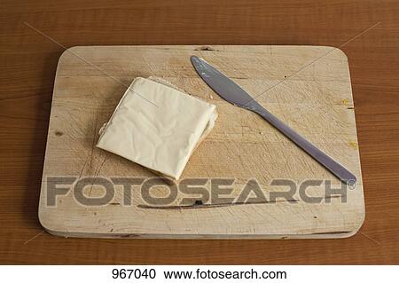 A slice of cheese on bread on a breadboard View Large Photo Image Stock Image - A slice of cheese on bread on a breadboard. Fotosearch