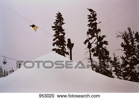 A snowboarder in mid-air View Large Photo Image Stock Image - A snowboarder in mid-air. Fotosearch