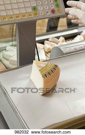 A wedge of cheese being weighed on a delicatessen scale View Large Photo Image Stock Image - A wedge of cheese being weighed on a delicatessen scale. Fotosearch