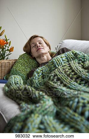 A woman napping on a sofa View Large Photo Image Stock Image - A woman napping on a sofa. Fotosearch