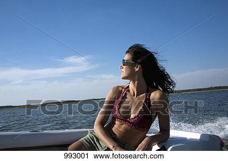 A woman relaxing in a motorboat View Large Photo Image Stock Image - A woman relaxing in a motorboat. Fotosearch