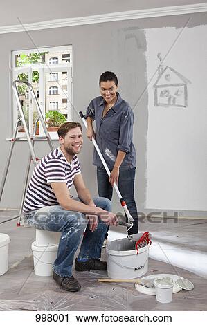 A young man and woman renovating an apartment View Large Photo Image Stock Image - A young man and woman renovating an apartment. Fotosearch