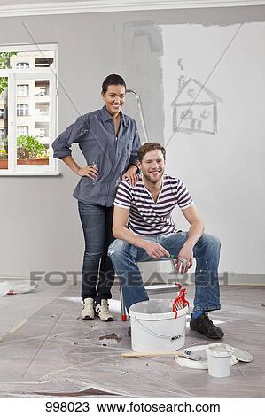 A young man and woman renovating an apartment View Large Photo Image Stock Image - A young man and woman renovating an apartment. Fotosearch