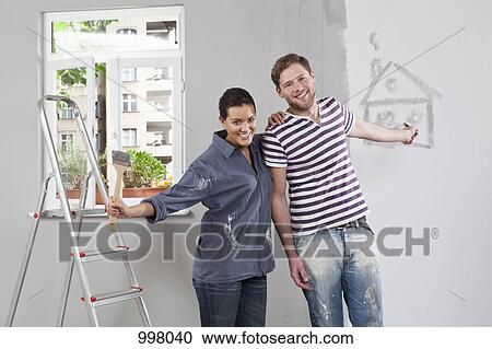 A young man and woman renovating an apartment View Large Photo Image Stock Image - A young man and woman renovating an apartment. Fotosearch