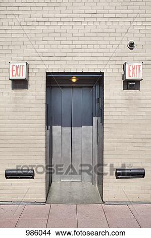 An elevator between two EXIT signs View Large Photo Image Picture - An elevator between two EXIT signs. Fotosearch
