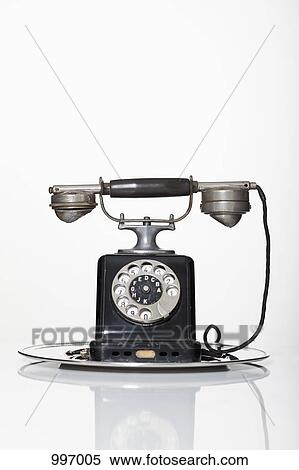 An old-fashioned rotary phone on a silver serving tray View Large Photo Image Stock Photography - An old-fashioned rotary phone on a silver serving tray. Fotosearch