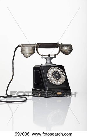 An old-fashioned rotary phone View Large Photo Image Stock Photograph - An old-fashioned rotary phone. Fotosearch
