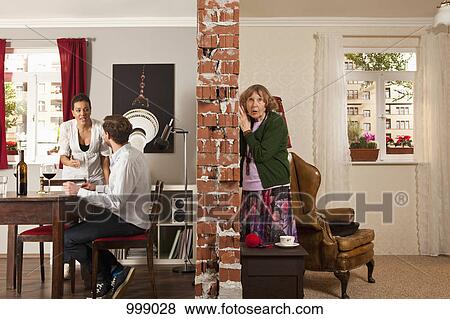 An senior woman listening to her neighbors arguing View Large Photo Image Stock Photo - An senior woman listening to her neighbors arguing. Fotosearch