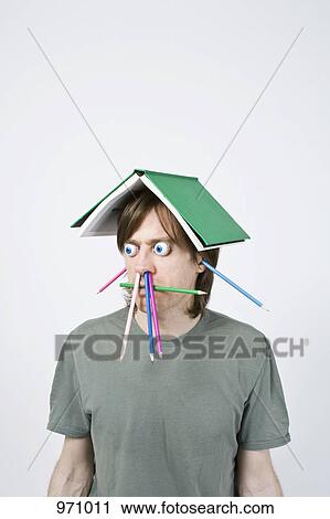 Bizarre man balancing book on head View Large Photo Image Stock Image - Bizarre man balancing book on head. Fotosearch