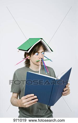 Stock Photo - Bizarre man reading a book . Fotosearch