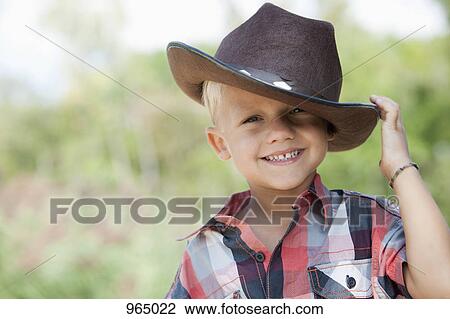 Boy tipping cowboy hat View Large Photo Image Stock Image - Boy tipping cowboy hat. Fotosearch