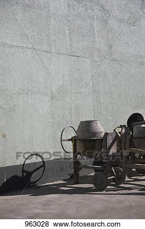 Stock Photo - Cement mixers next to a building. Fotosearch
