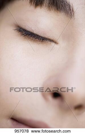 Close-up of a young woman's face View Large Photo Image Stock Photo - Close-up of a young woman's face . Fotosearch