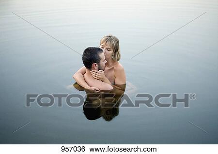 Couple embracing in water View Large Photo Image Stock Photograph - Couple embracing in water. Fotosearch