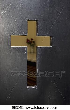 Detail of a cross cut-out in the door of a church View Large Photo Image Stock Image - Detail of a cross cut-out in the door of a church. Fotosearch
