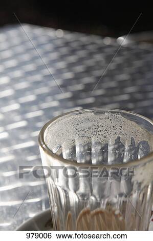 Detail of an empty coffee cup on a table at a cafe View Large Photo Image Stock Photograph - Detail of an empty coffee cup on a table at a cafe. Fotosearch